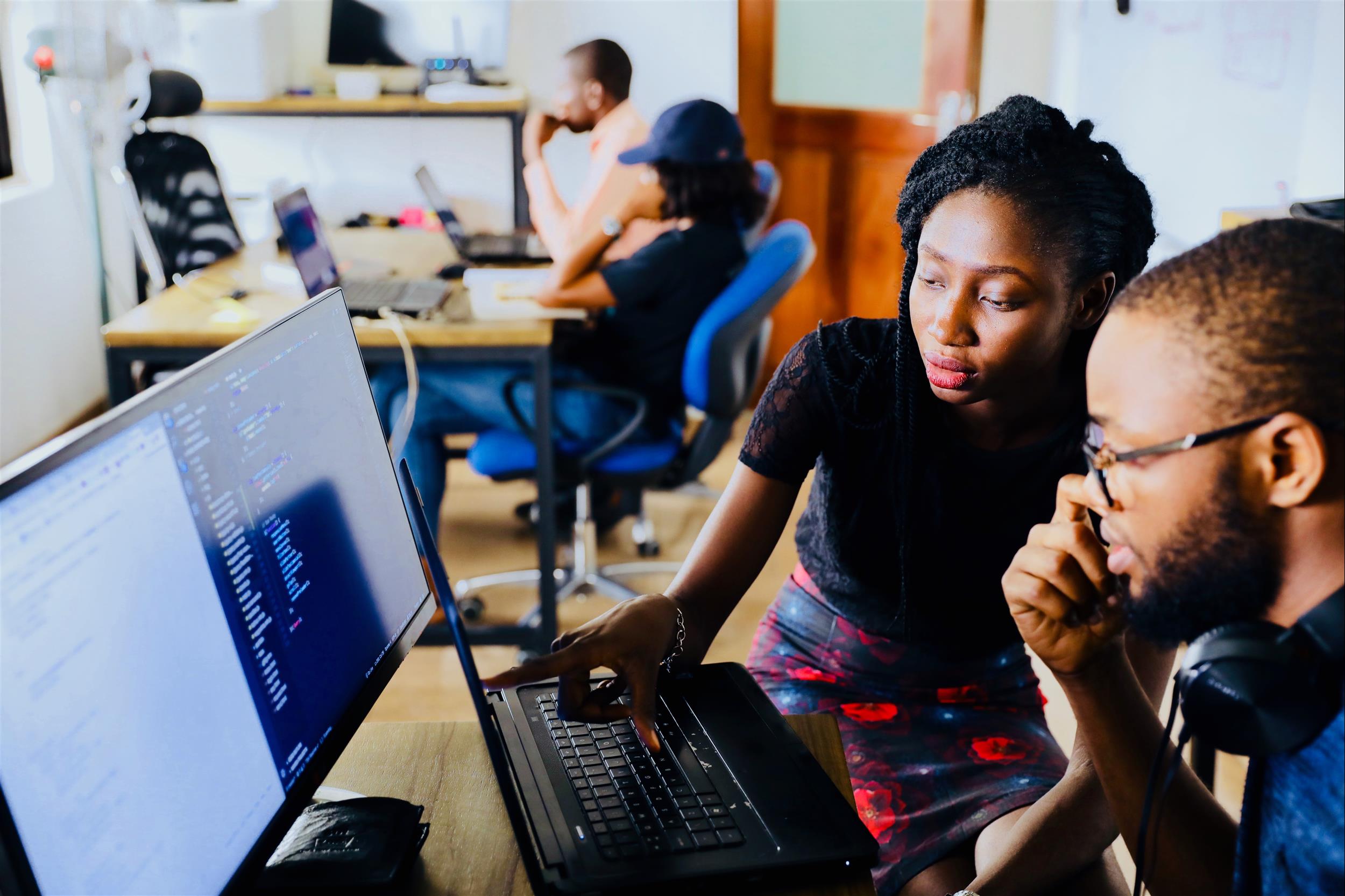 two people looking at a computer